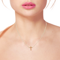 Load image into Gallery viewer, Model wearing a dainty 14k gold cross necklace, showcasing its elegant design and ideal fit for everyday wear.
