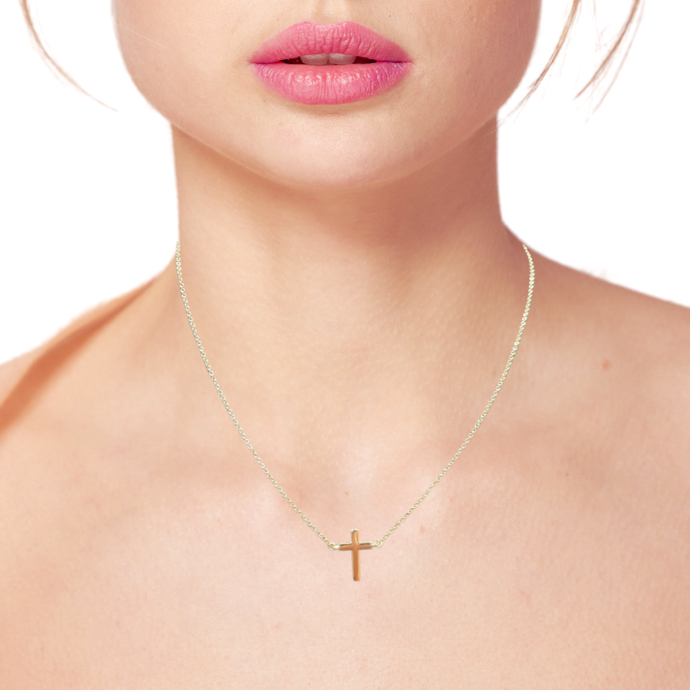 Model wearing a dainty 14k gold cross necklace, showcasing its elegant design and ideal fit for everyday wear.