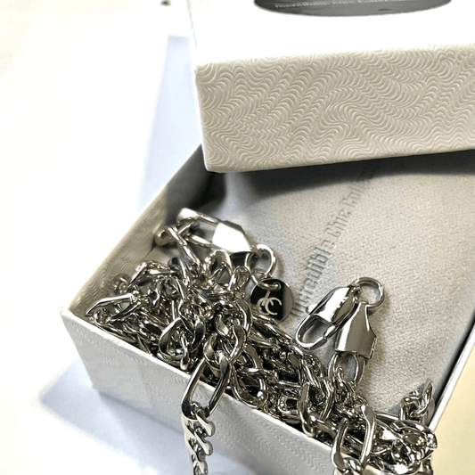 Silver Figaro chain necklace displayed in a stylish box, showcasing its elegant design and craftsmanship.